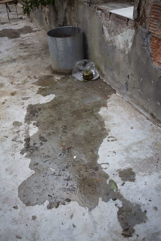 Dark wet patch on the concrete floor where I lay down to read